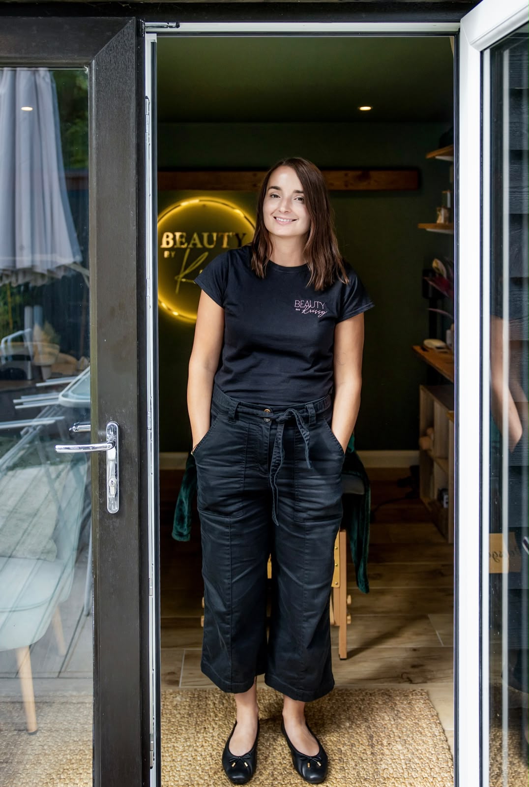 Krissy standing in the doorway of her Beauty by Krissy studio